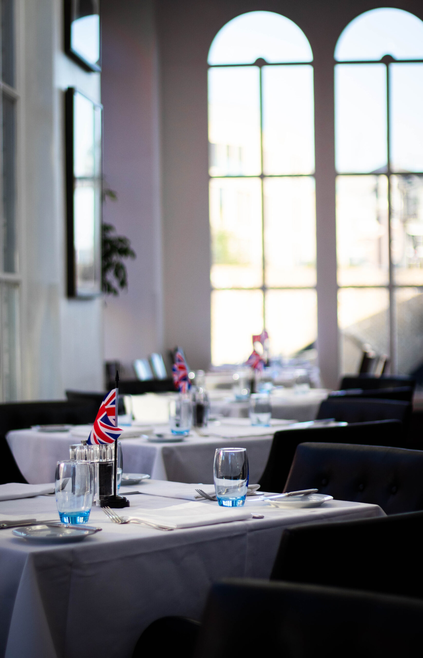 Well dressed tables in a fancy restaurant.