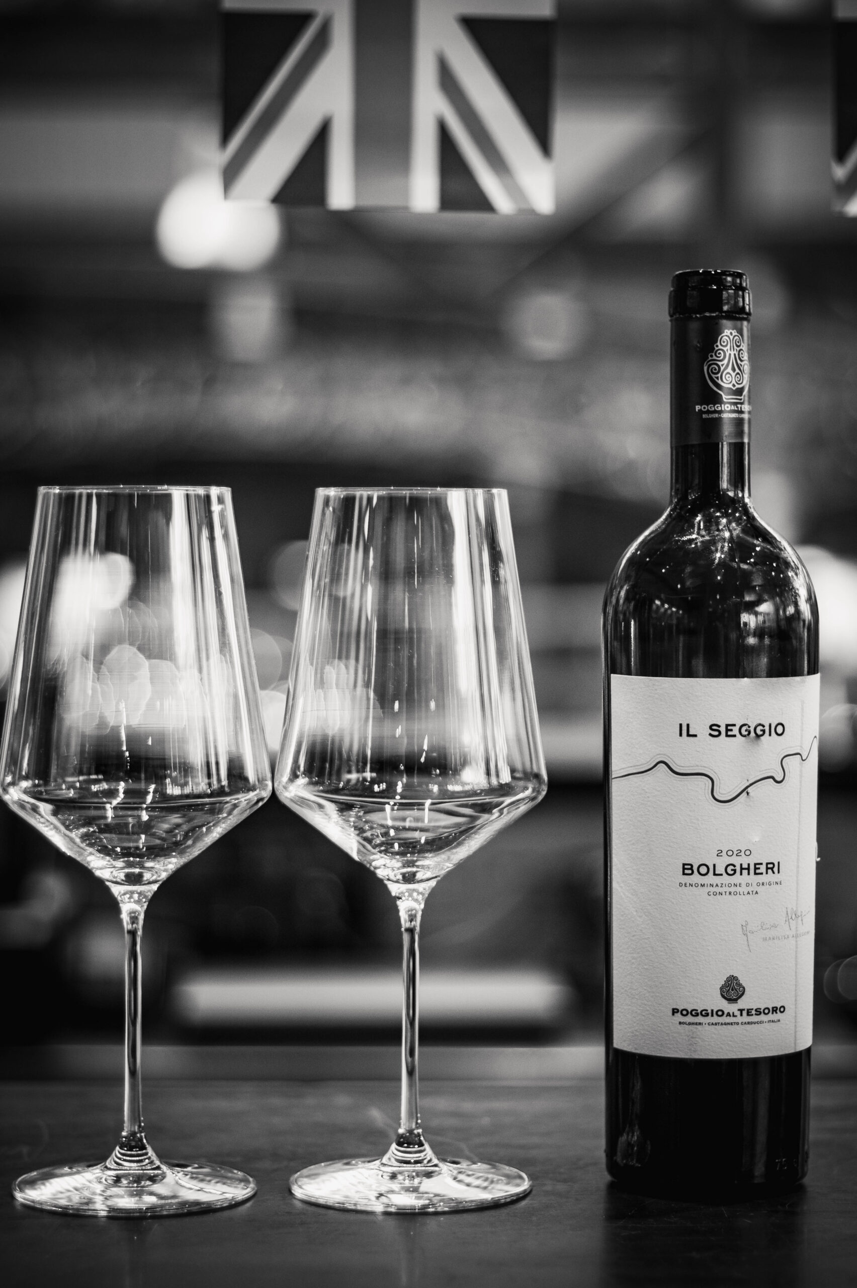 Picture of wine glasses and a bottle of wine in black and white.